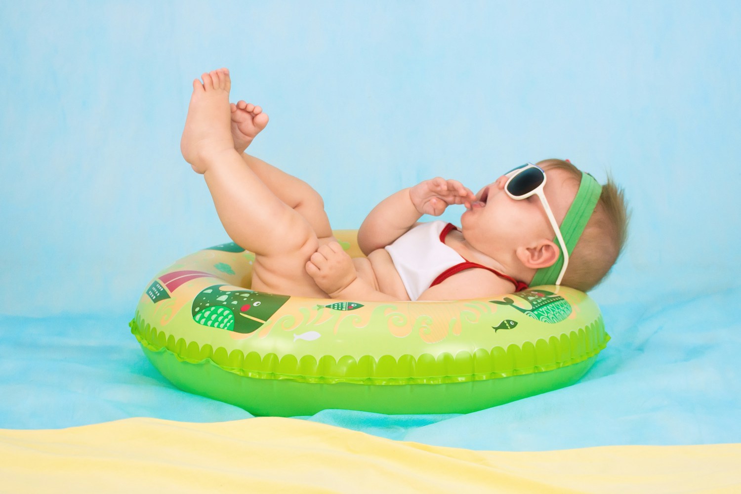 A cheerful baby wearing sunglasses — illustrative photograph
